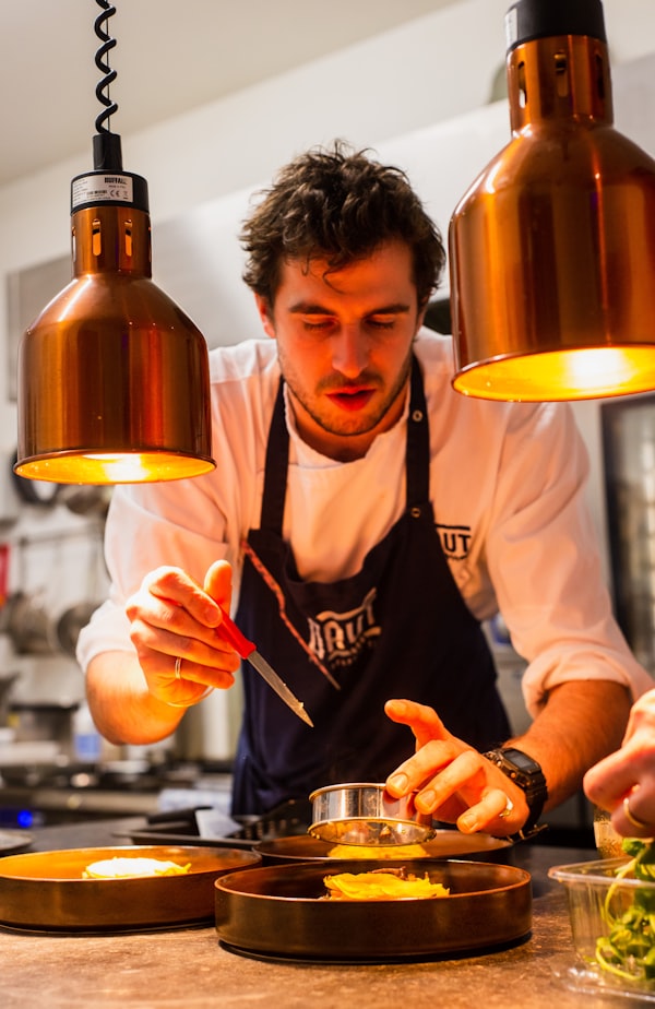 Head chef working the pass in a professional kitchen